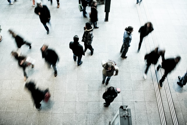 Overhead shot of multiple people in suits walking.