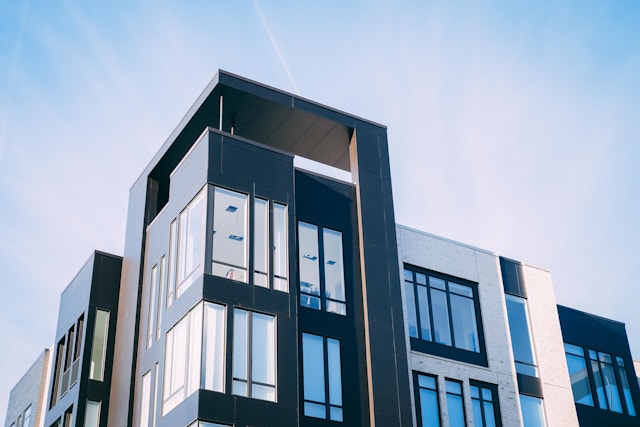 Image of modern apartment complex with large windows.